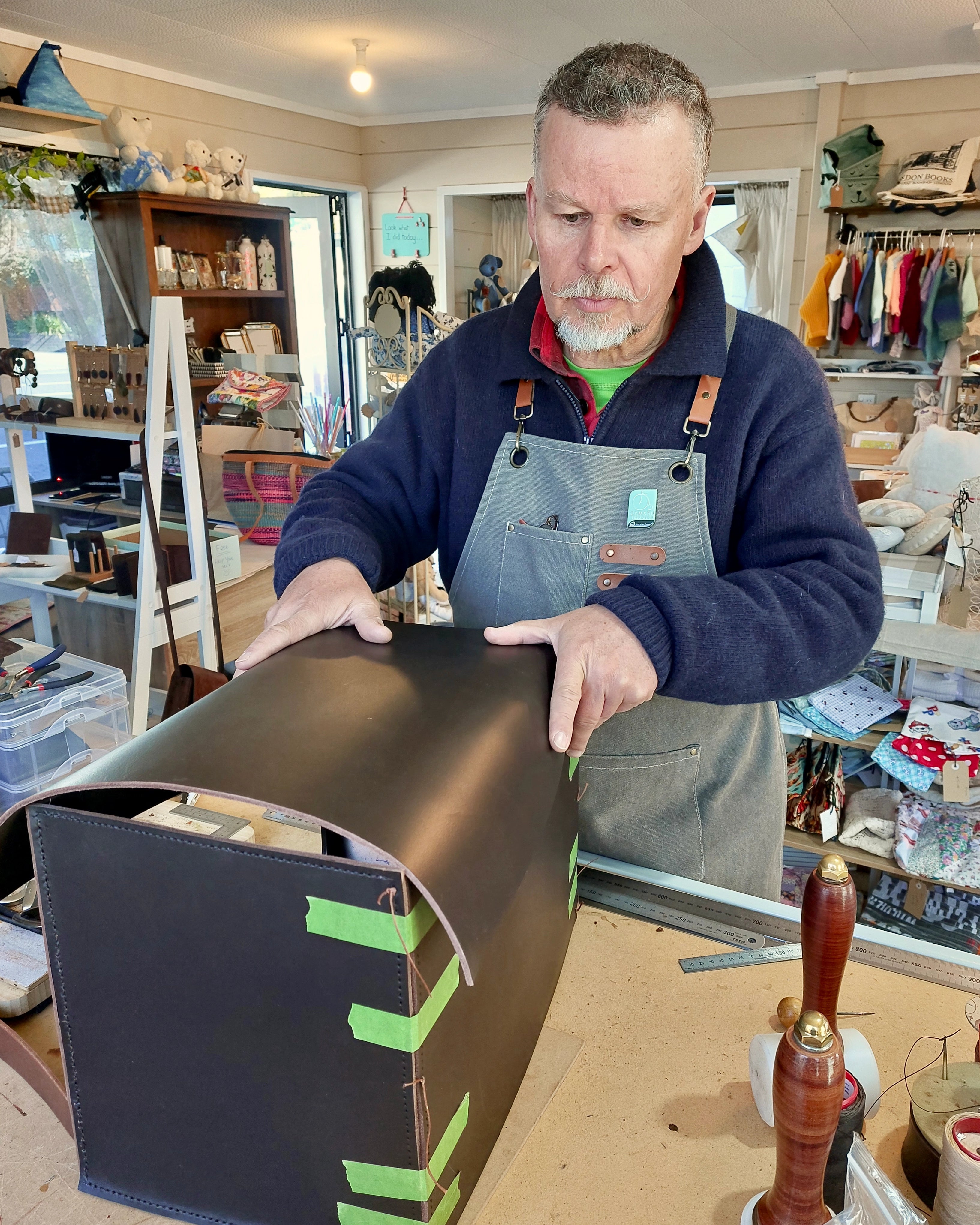 Leather craftsman Don hand-crafting a suitcase in the Albannach Crafts workshop.