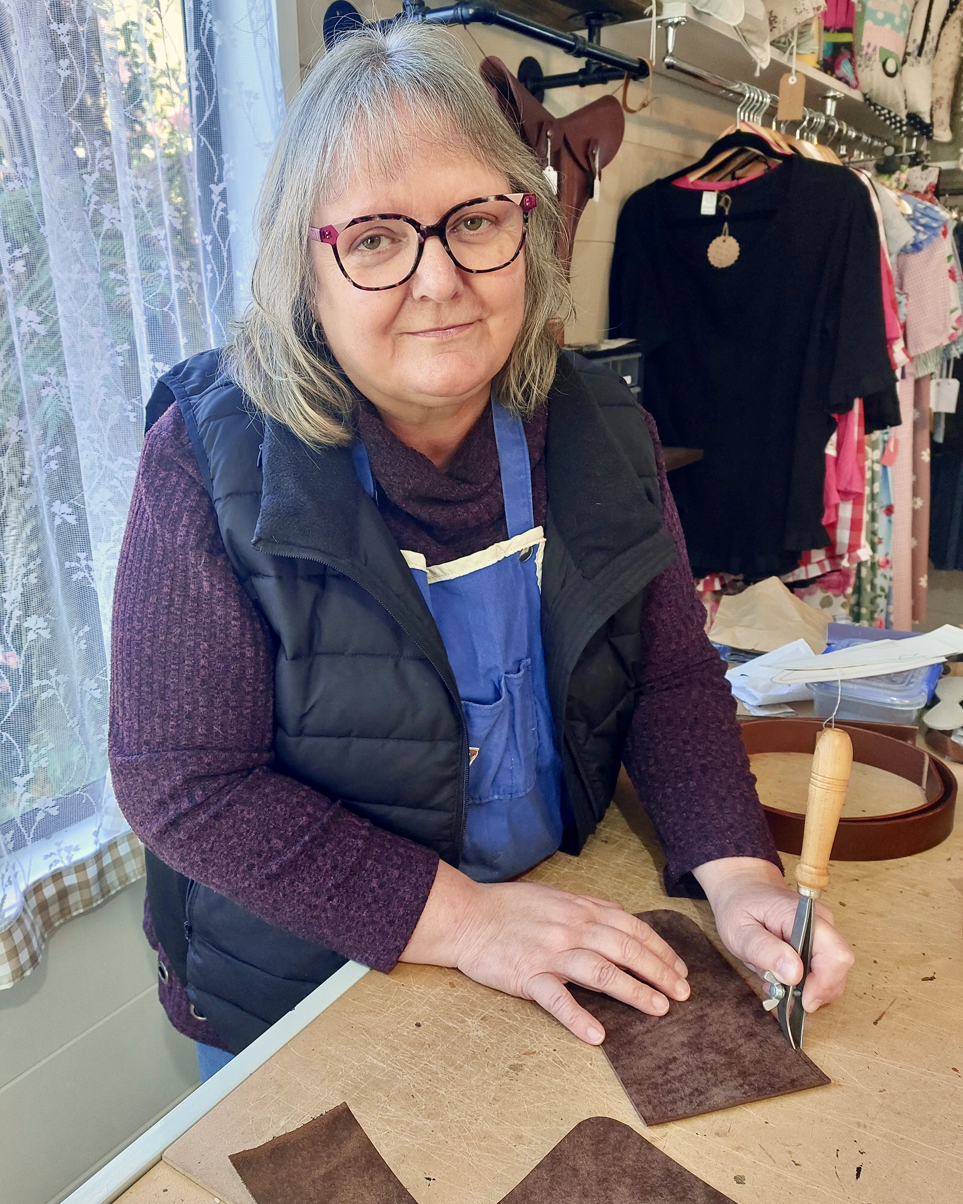 Leather-craft apprentice Denise hand-crafting a piece in the Albannach Crafts workshop.