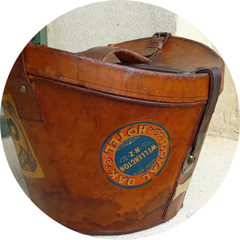 Restored vintage leather case with brass hardware, with old stickers of New Zealand cities.