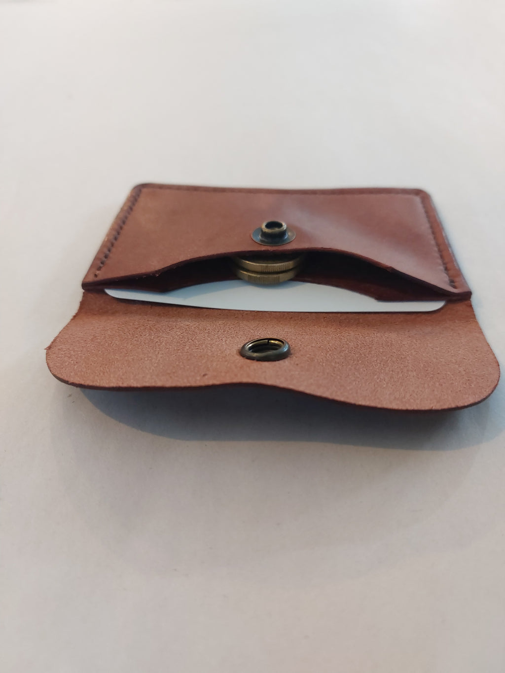 Internal view of the Minimalist Card & Coin Purse in Whiskey made with rich brown marble-effect leather, with the flap open.