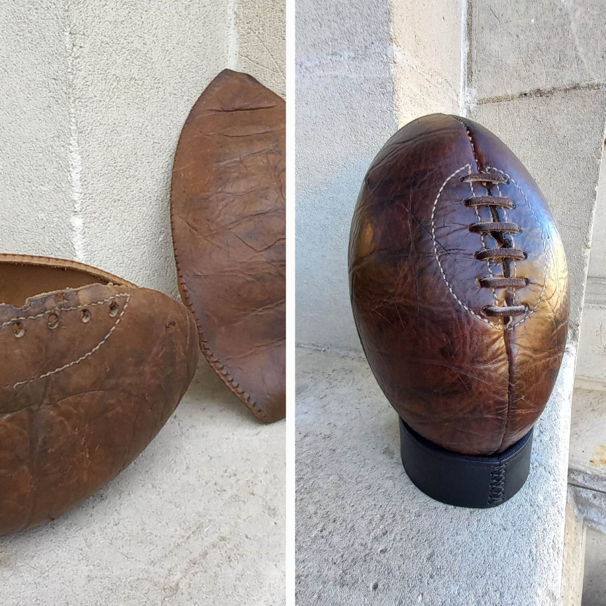 A side-by-side look at a rugby or American football in it's pre-restoration and post-restoration state. Hand-made with dark brown leather.