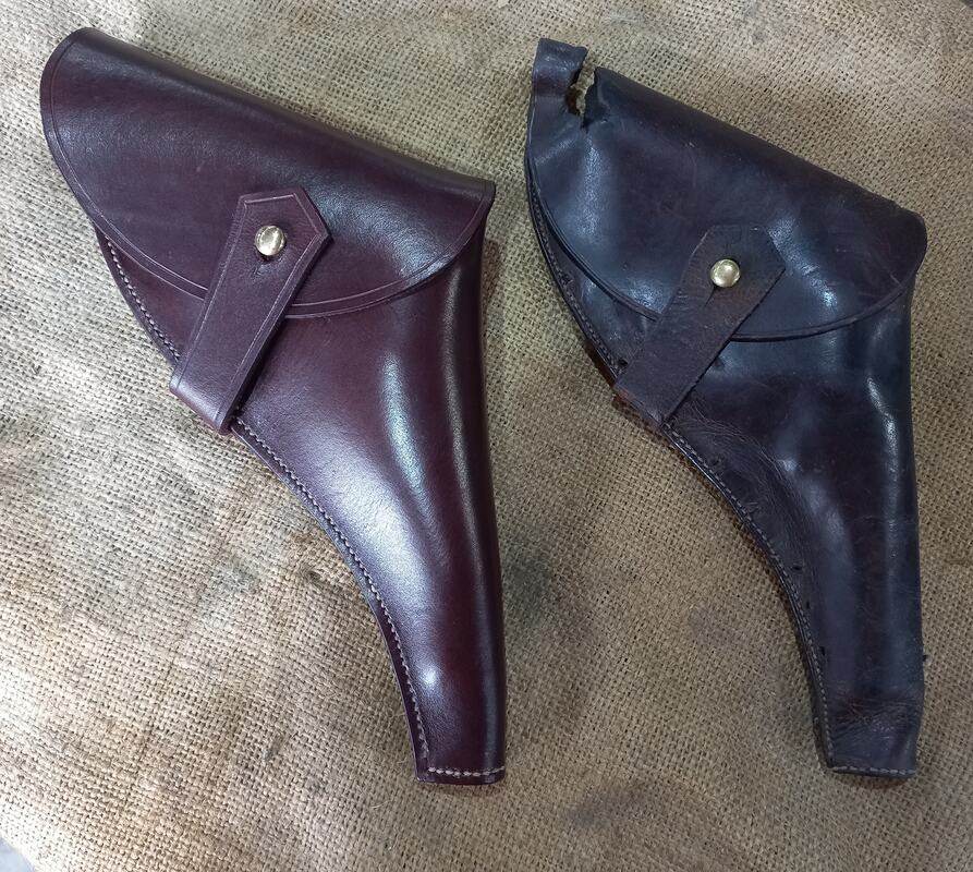 An old holder made from a faded dark brown leather with a rip in the top, placed next to a replica hand-made with a polished red brown leather.