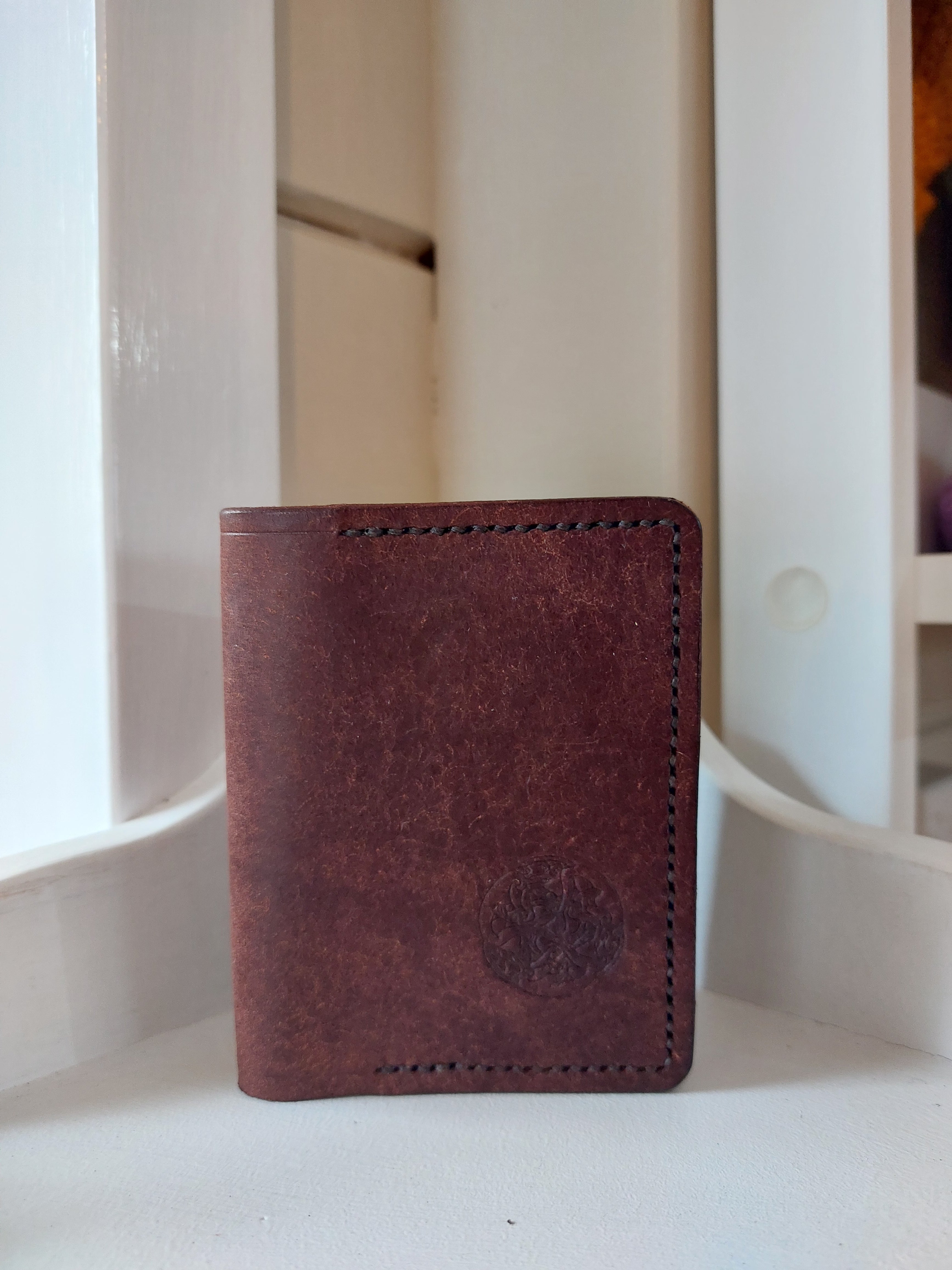 Card Case made from Chestnut Brown vegetable-tanned leather, and stamped with the Albannach Crafts logo.