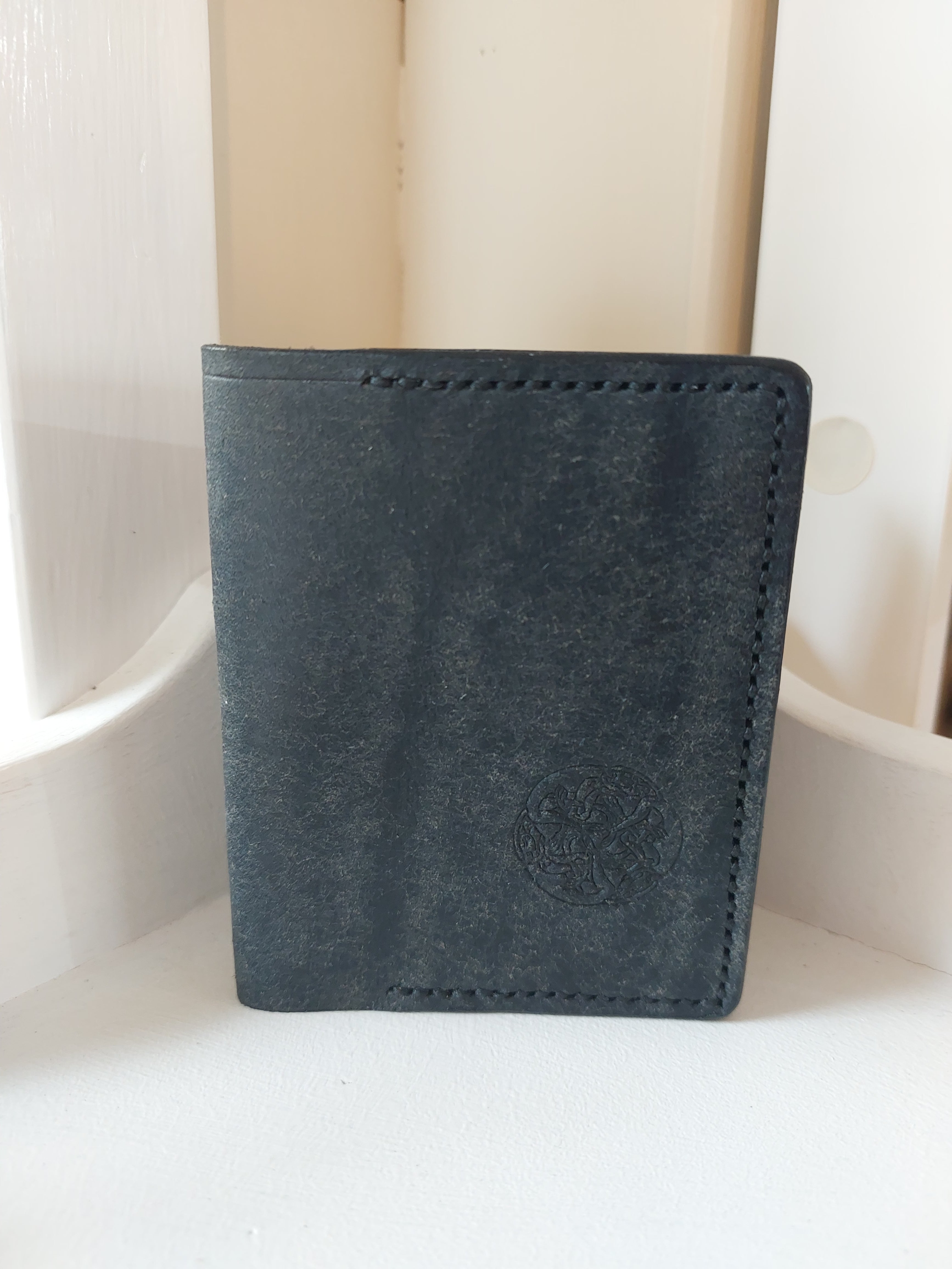 Card Case made from Navy Blue dyed vegetable-tanned leather, and stamped with the Albannach Crafts logo.