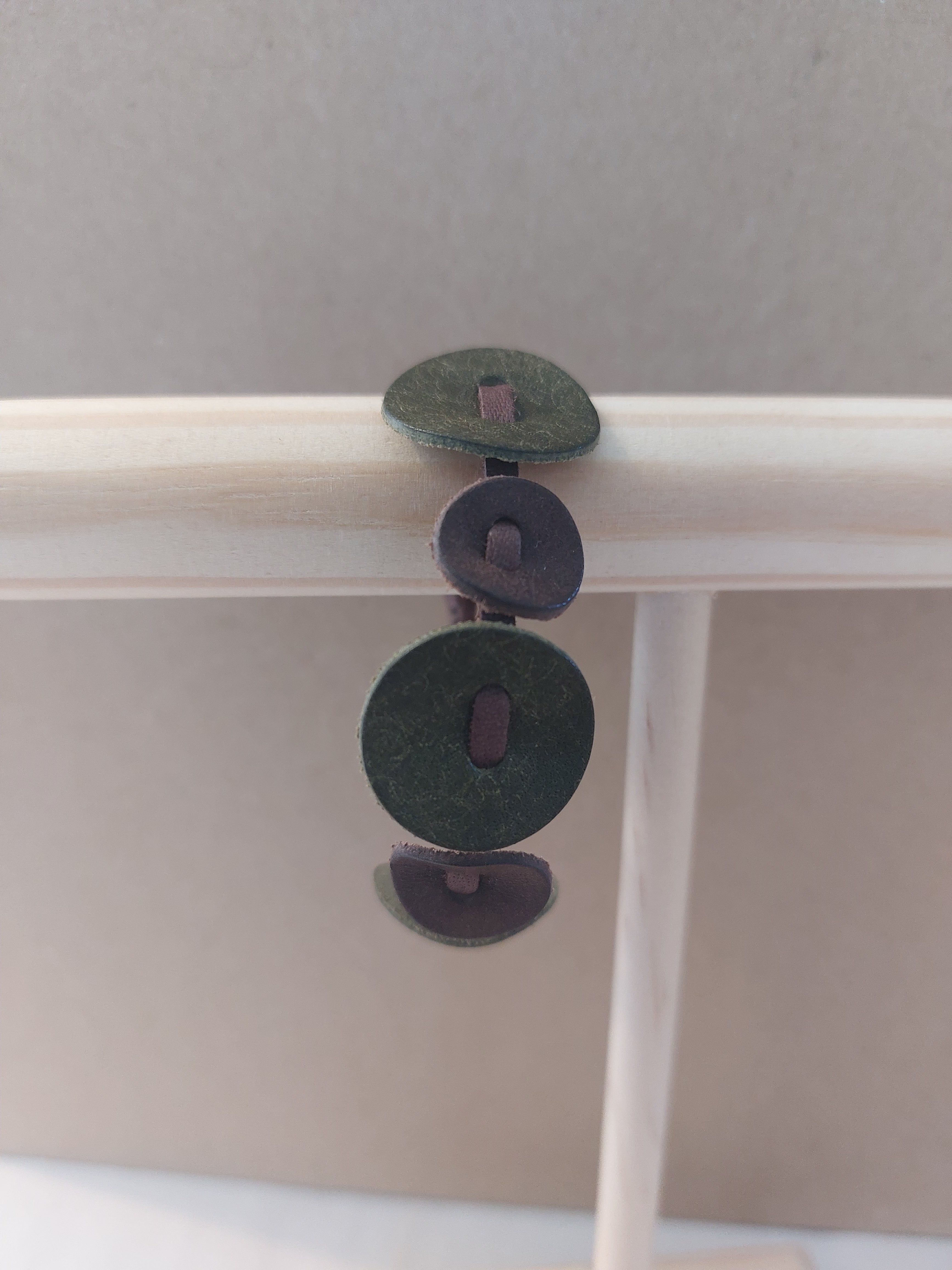 Green Circle Bracelet made with small circles of scrap leather.