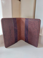 Inside look at the Card Case made from Chestnut Brown vegetable-tanned leather, with contrasting purple interior pockets and stamped with the Albannach Crafts logo.