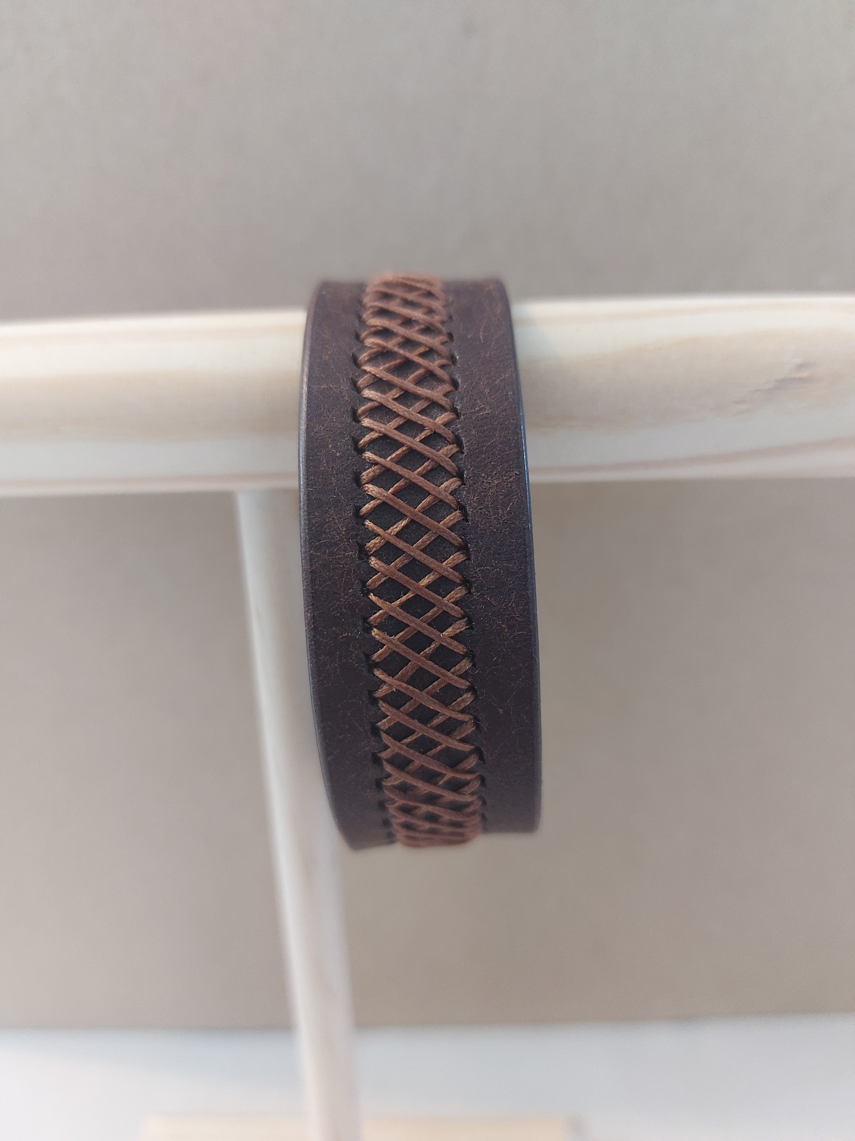 Weave Braid Bracelet made with dark brown leather and light brown stitching.