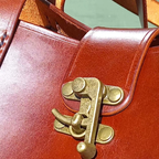 Close-up of the OTT - One Tough Tote's bag clasp hardware in brass.