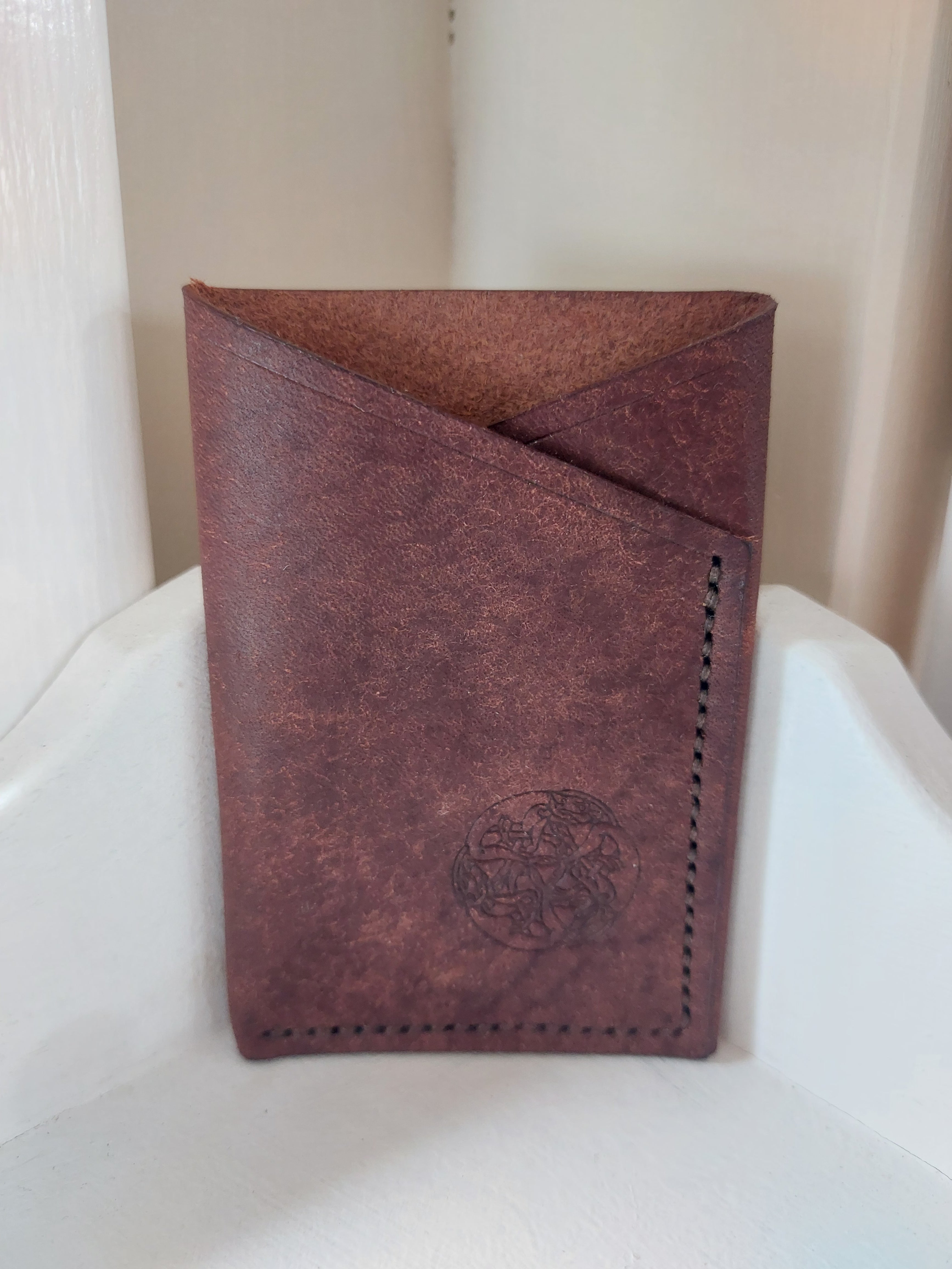 Minimalist Card Case made from Brown vegetable-tanned leather, and stamped with the Albannach Crafts logo.