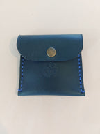 Simple Coin Purse made with navy blue dyed vegetable-tanned leather and finished with a brass closure. Stamped with the Albannach Crafts logo.