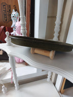 Side angle of the Oval Catch-All Tray handmade with Olive Green dyed leather, created using the wet-forming technique. Stamped with the Albannach Crafts logo.