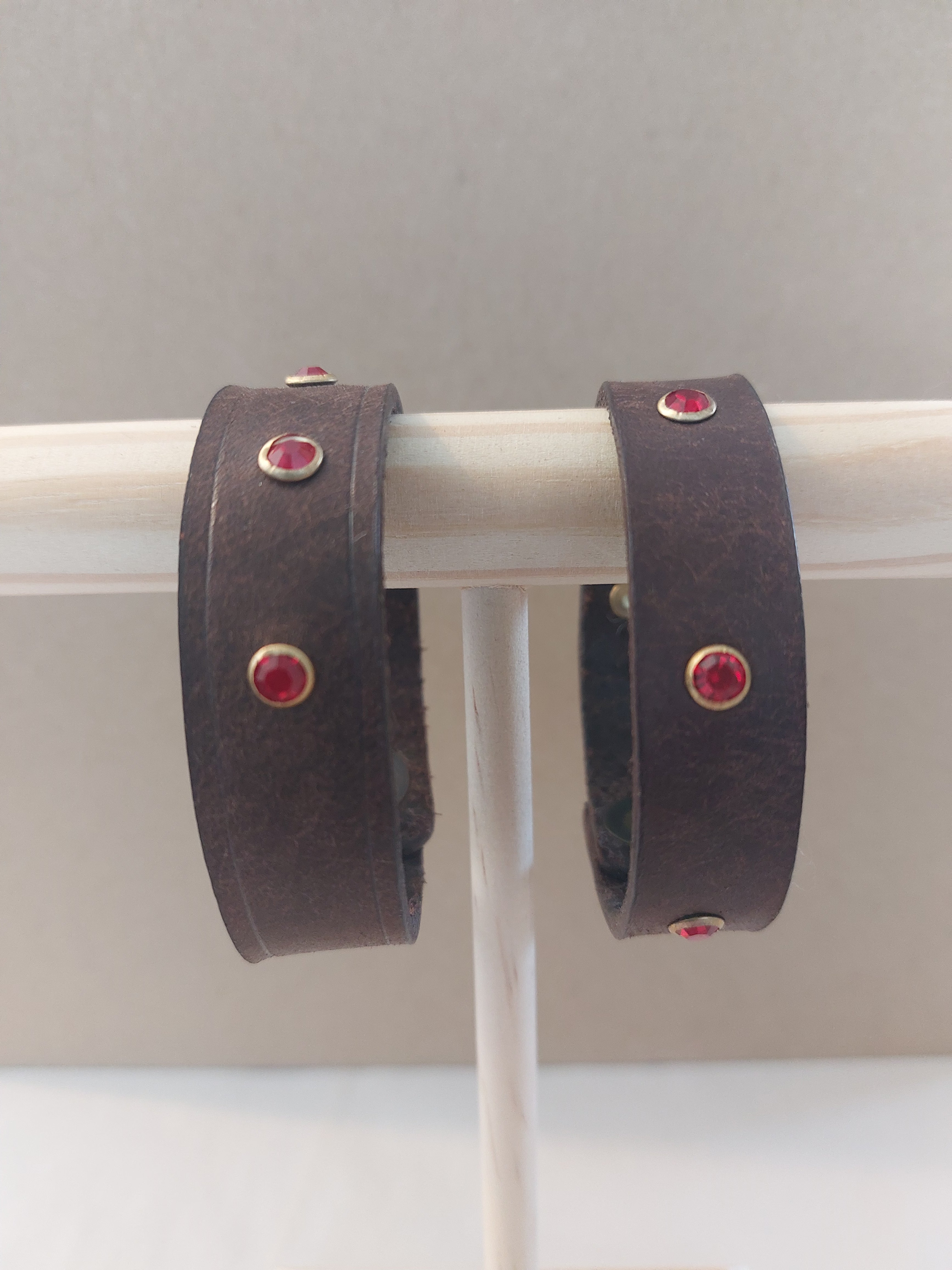 Red Studded Bracelet made with dark brown leather.