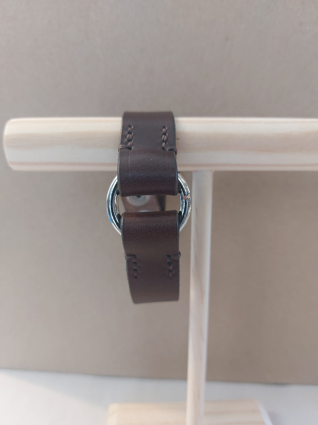 Front view of Silver Circle Bracelet made with dark brown leather.