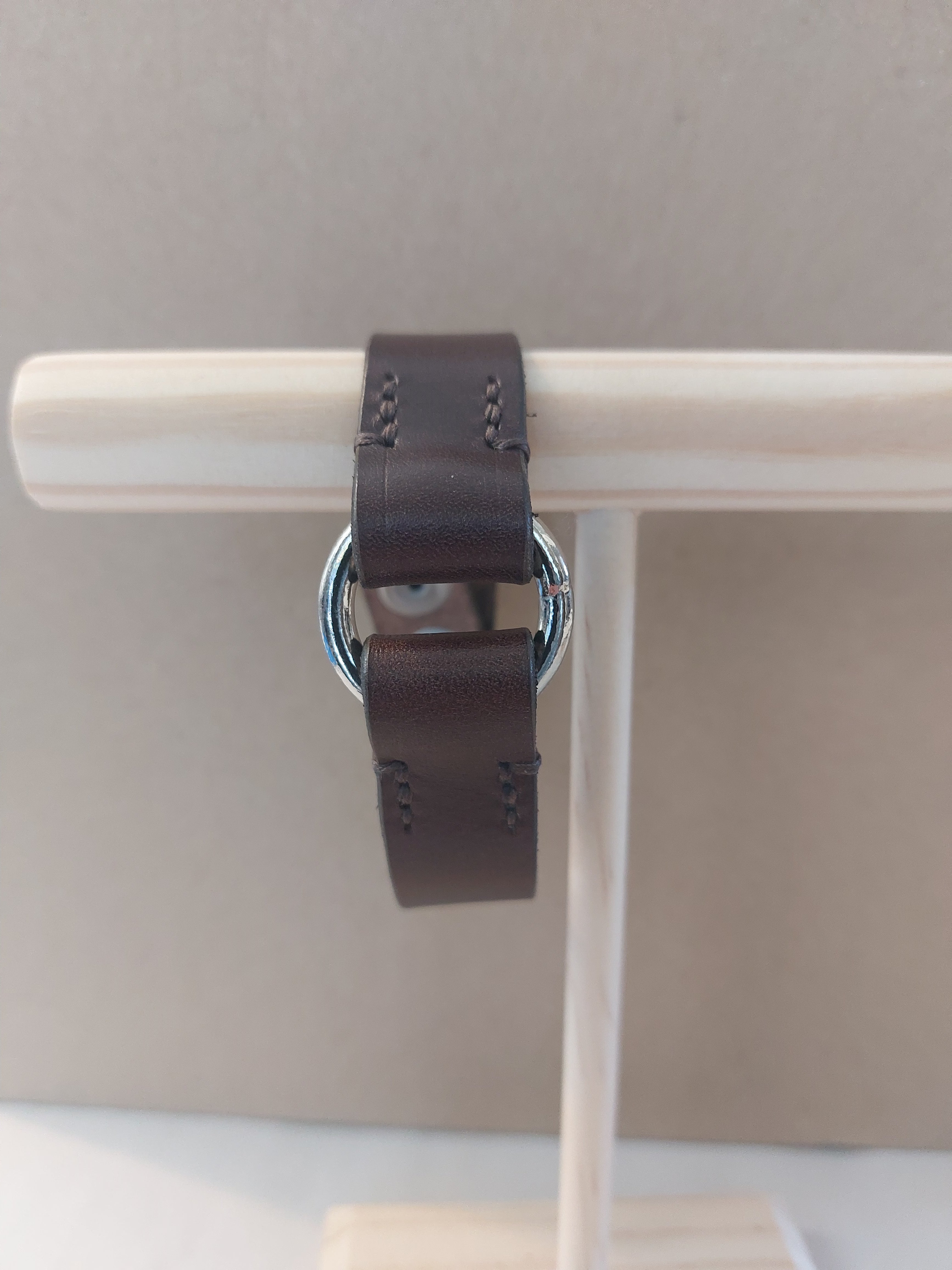 Front view of Silver Circle Bracelet made with dark brown leather.