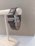 Silver Circle Bracelet made with dark brown leather.