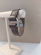 Silver Circle Bracelet made with dark brown leather.
