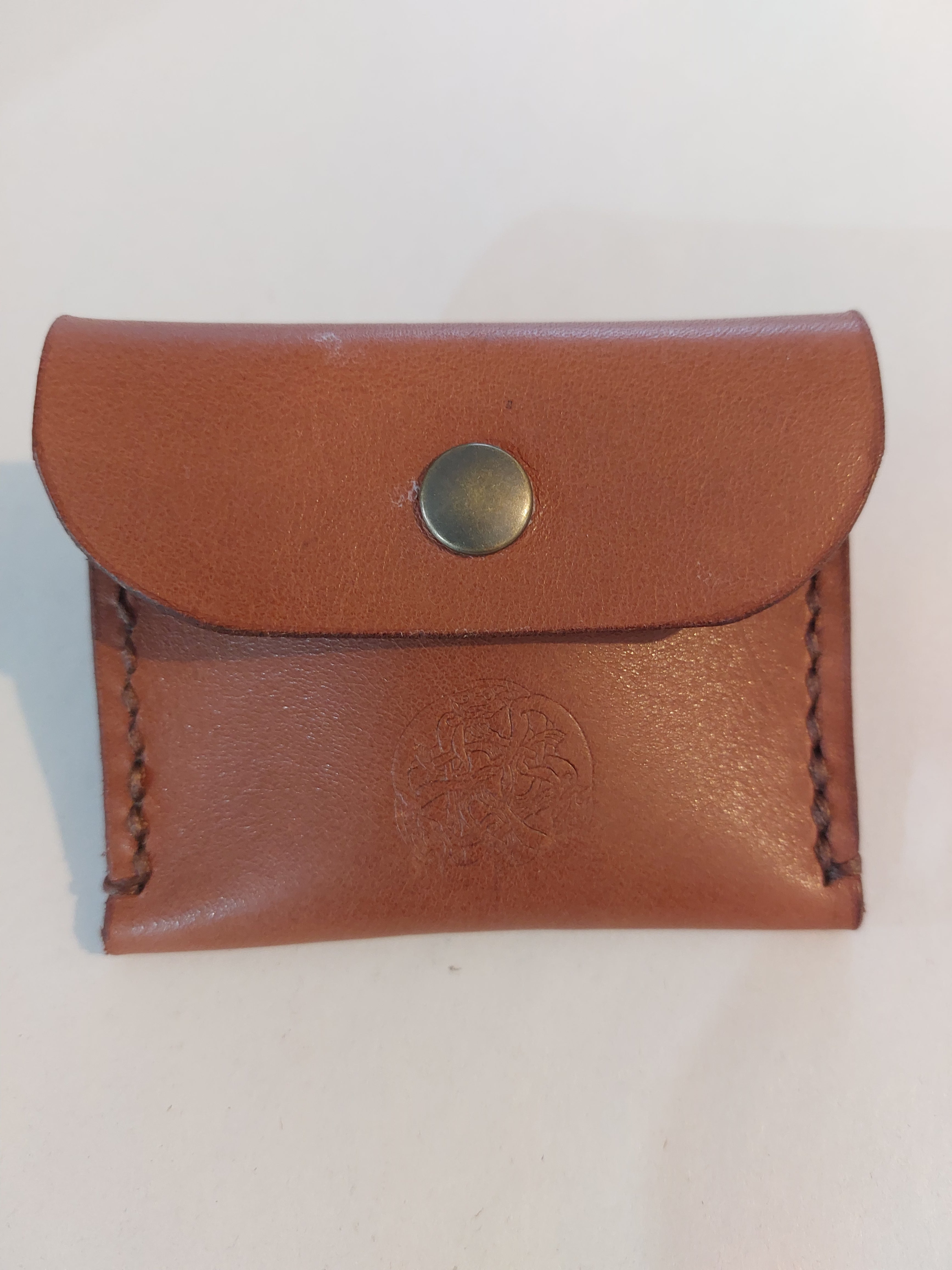 Simple Coin Purse made with tan brown vegetable-tanned leather and finished with a brass closure. Stamped with the Albannach Crafts logo.