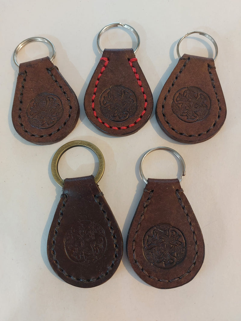 Five Traditional Key Fobs made with brown vegetable-tanned leather and stamped with the Albannach Crafts logo. Different options for stitch colours available.