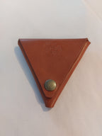 Triangle Coin Purse made with light brown vegetable-tanned leather, with a brass closure.