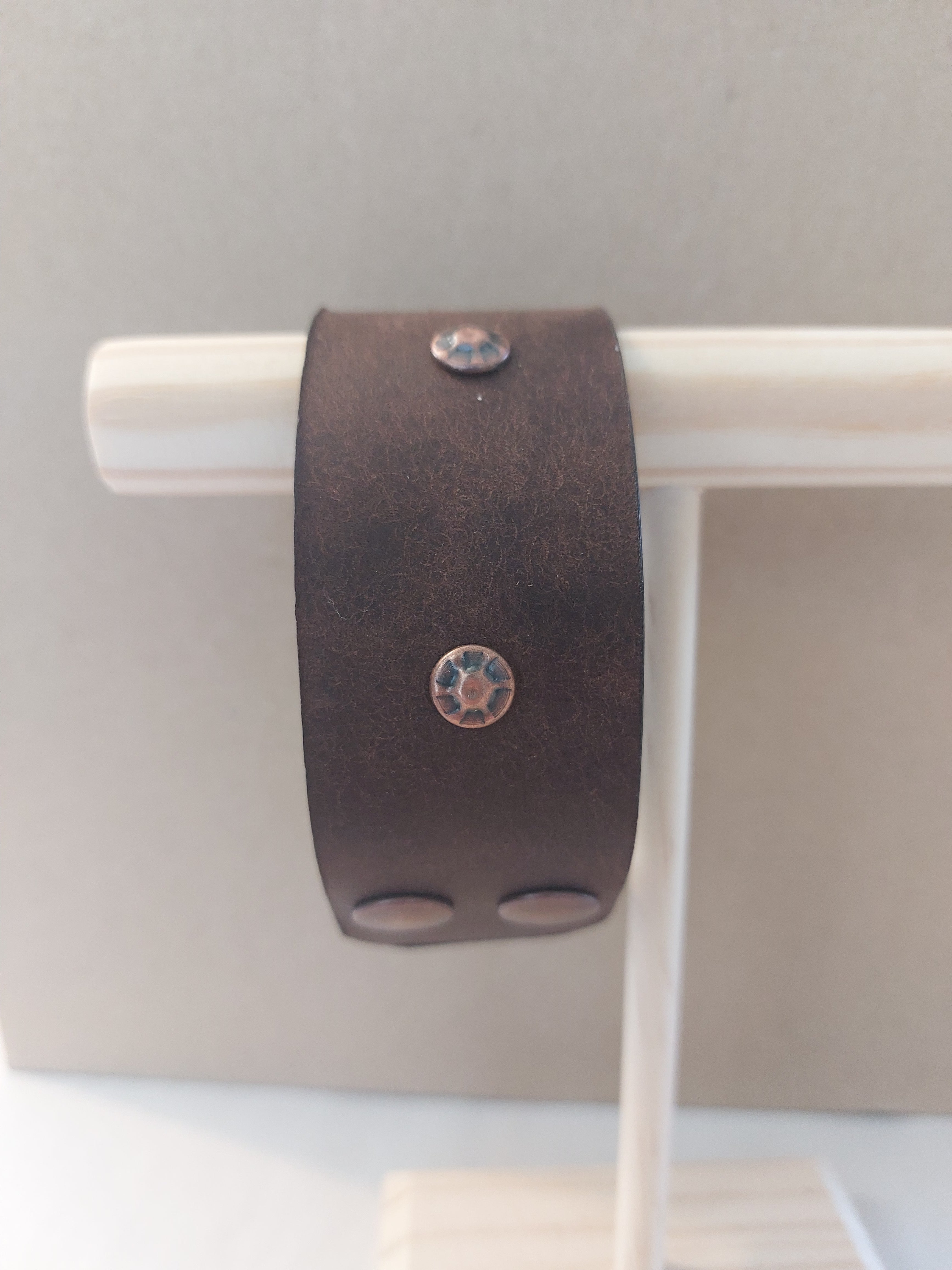 Wide Band Bracelet with Copper Rivets, made with dark brown leather.
